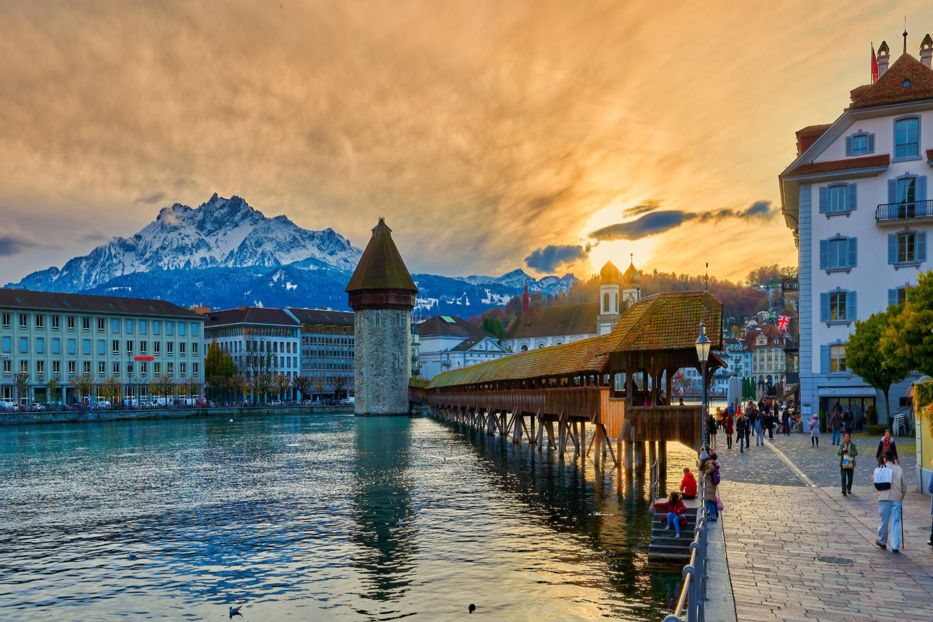 The Chapel Bridge and water tower in Lucerne, Switzerland at sunset
